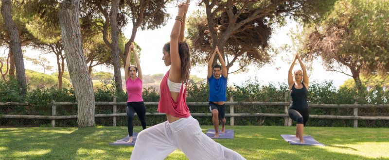 group yoga class in the garden at Pine Cliffs